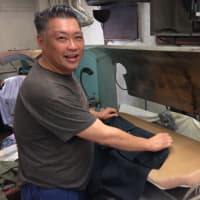 <p>Eric Moy steps in to press shirts. </p>