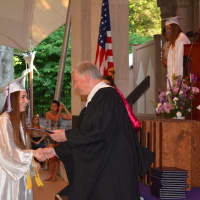 <p>A John Jay High School 2014 graduate receives her diploma.</p>