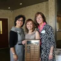 <p>Carmen Seleme-McDermott, left, and Measi O&#x27;Rourke, right, of the St. Joseph Parenting Center in Stamford present a Volunteer of the Year plaque to Lily Vasquez.</p>