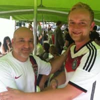 <p>Lou Pasquino, left, wearing a U.S. jersey shakes hands with German fan Robert Warnecke after Germany&#x27;s 1-0 win in World Cup action Thursday.</p>