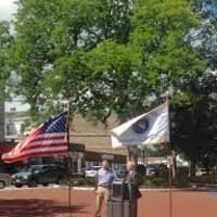 <p>Mayor Mark Bouhton and DPW Director Antonio Iadarola are flanked by flags at the ribbon-cutting for Kennedy Park. </p>