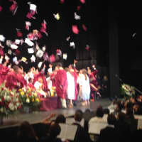 <p>The 245 graduating Harrison High School seniors toss their caps at the end of the ceremony Friday at SUNY Purchase. </p>