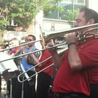 <p>Steve Lange on the trombone, a member of a scaled down Boston Pops Orchestra, performs in Stamford. </p>