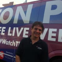 <p>Boston Pops Orchestra Music Conductor Keith Lockhart in front of the tour bus parked on Bedford Street in Stamford on Monday afternoon. </p>