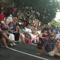<p>The audience watches and listens as a mini Boston Pops Orchestra performs on Bedford Street  Monday. </p>