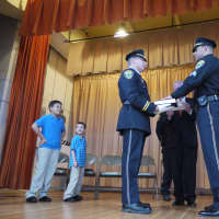 <p>Sgt. Edward Nook is sworn in by Fairfield First Selectman Michael Tetreau with his two sons standing to the side. </p>