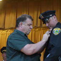 <p>Fairfield Detective Anthony Vaspasiano has his father present him with his new badge. </p>