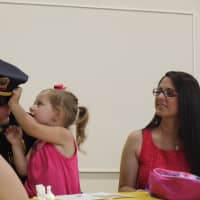 <p>Later, Sgt. Michael Paris is congratulated by his wife and 3-year-old daughter Layla. </p>