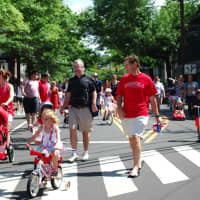 <p>Participants proceeding down the Post Road in the 2013 Push-n-Pull Parade.</p>