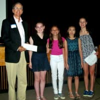 <p>Hillary O&#x27;Neill, Ellie Arrow, Lia Chen, and Mia Fraas donate a check to Jeff Weiser from Homes with Hope</p>