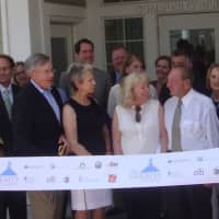 <p>Henry and Donna Kelly, surrounded by local, state and federal officials, prepare to cut the ribbon on the Heights at Darien.</p>
