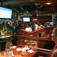 <p>John Peters of White Plains and his fiance watch the World Cup game between USA and Belgium at Ron Blacks July 1. </p>