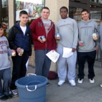 <p>Art Troilo Jr., right, with Harrison football players who collected 350 cans of soup to be donated to a local food pantry. </p>