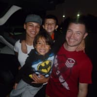 <p>Diana (left), Andres (right) and their children Alejandro (front), 5, and Andres Jr. (back), 6, watch fireworks from their car. </p>