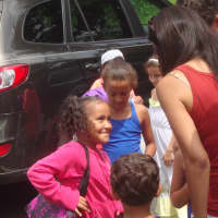 <p>Venus greets the Lee family as she arrives off the bus in Ridgefield for her Fresh Air Fund experience.</p>