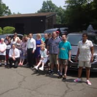 <p>Norwalk representatives, STAR Inc. staff and STAR clients with the fleet of new vans purchased with a state grant.</p>