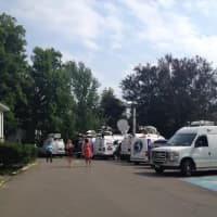 <p>Trucks from television stations line the road near the Ridgefield Police Department. </p>