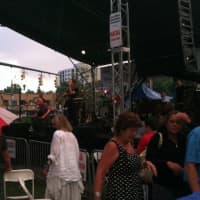 <p>The audience scrambles for cover as rain comes down during the Bacon Brothers performance at Jazz Up July on Wednesday at Columbus Park in Stamford. The show resumed after a 15-minute break.</p>