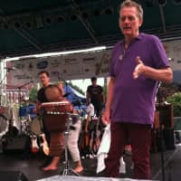 <p>Michael Bacon talks to fans during a break due to rain while brother Kevin, in center of photo, prepares to resume performing. The rain forced a 15-minute halt of the Bacon Brothers show at Jazz Up July on Wednesday in Stamford.</p>