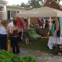 <p>Shoppers peruse items for sale outside the Darien Thrift Shop.</p>