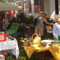 <p>Shoppers peruse items for sale outside the Darien Thrift Shop.</p>