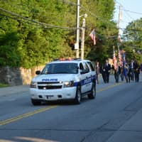 <p>A Mount Kisco police vehicle leads the parade.</p>