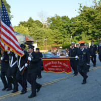 <p>Bedford Hills firefighters march in the parade.</p>