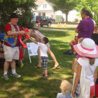 <p>Mr. Bungles makes balloon animals for kids at the street fair.</p>