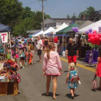 <p>Shoppers enjoy a summer day in Wilton Center by checking out local businesses at the Wilton Street Fair.</p>
