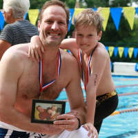 <p>Teddy Meyer swimming with his dad, Scott, in honor of his grandfather in the Chappaqua Swim &amp; Tennis Club&#x27;s Swim Across America fund-raiser, July 13.

</p>
