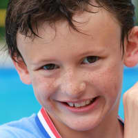 <p>A proud swimmer after doing his part for the Swim Across America fund-raiser at Chappaqua Swim &amp; Tennis Club.</p>