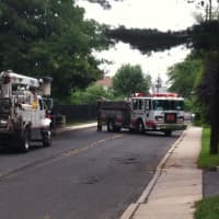 <p>The Norwalk Fire Department blocks Ely Avenue with fire engines on Tuesday morning after a pole caught fire, causing power outages through the neighborhood. </p>