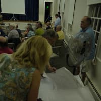 <p>Fairfield residents look over several maps provided by town Tree Warden Ken Placko about which trees might be coming down in the next few years. </p>