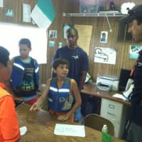 <p>Instructor Will Burdick listens as Jason Velez, 11, answers a sailing question. Also pictured are Erick Dominguez, 11, in orange shirt, Ricardo Raposo, 11, and staff member Mekhi Barnettt, 15, in back.</p>