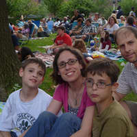<p>Sarah and Dan Wigodsky bring their children Nadav (left), 9, Alon (second from right), 9 and Deena (not pictured), 9 to watch Shakespeare in the Park. </p>