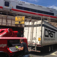 <p>Vincent Towing pulled the 18-wheeler, CRST Premier Transport truck out from under the Metro-North overpass at 2 p.m.</p>