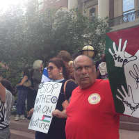 <p>Luis Quiros (right) and Guisela Marroquin (second from right) demonstrate on the steps of White Plains City Hall. </p>