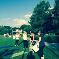 <p>Maureen Horton and her yoga class at Riverfront green Park in Peekskill, July 17.</p>