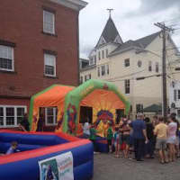 <p>A kids entertainment area is set up as part of Ridgefield Rewinds Summerfest. </p>