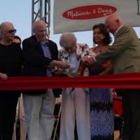 <p>Mimi Levitt, with Westport First Selectman Jim Marpe, former First Selectman Gordon Joseloff and Freda Welsh, cuts the ribbon opening the new pavilion.</p>