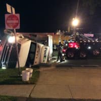 <p>A FedEx tractor-trailer lies in the roadway on the Post Road in Fairfield early Wednesday after a rollover accident.</p>
