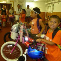 <p>George Estrada, right, 5, is happy with his new bicycle. </p>