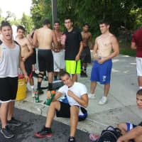 <p>Carmel Rams football players take a break between running and agility drills at the school on July 23.</p>