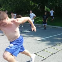 <p>A Carmel High School football players strains for that extra burst during a sprint drill.</p>