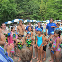 <p>Willowbrook Swim &amp; Dive&#x27;s senior swimmers lead a team cheer during the Tuesday, July 22, meet with Birchwood.</p>