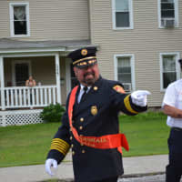 <p>A Brewster parade marshall gestures during his march.</p>