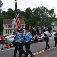 <p>Putnam Valley firefighters march in the Brewster parade.</p>
