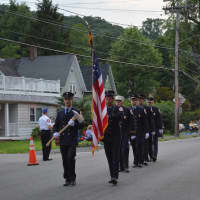<p>Danbury firefighters march in the Brewster parade.</p>