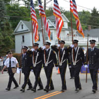 <p>Lake Carmel firefighters march in the Brewster parade.</p>