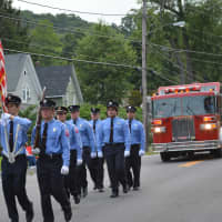 <p>Patterson firefighters march in the Brewster parade.</p>